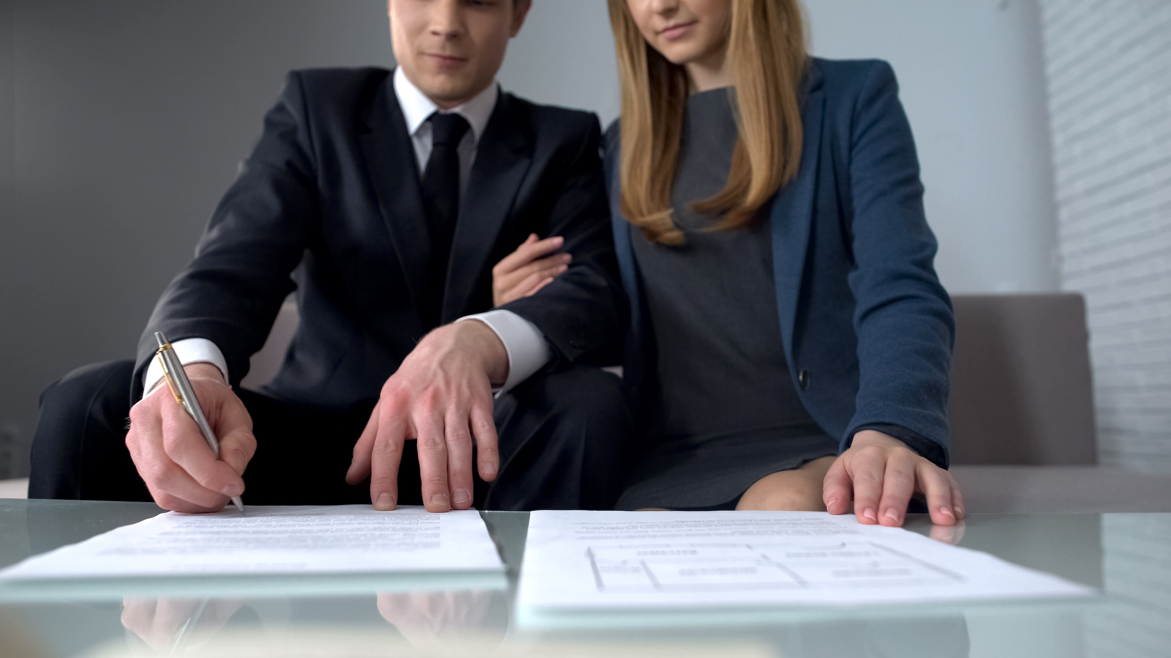 Young Couple Signing Their Wills | One80Law Group