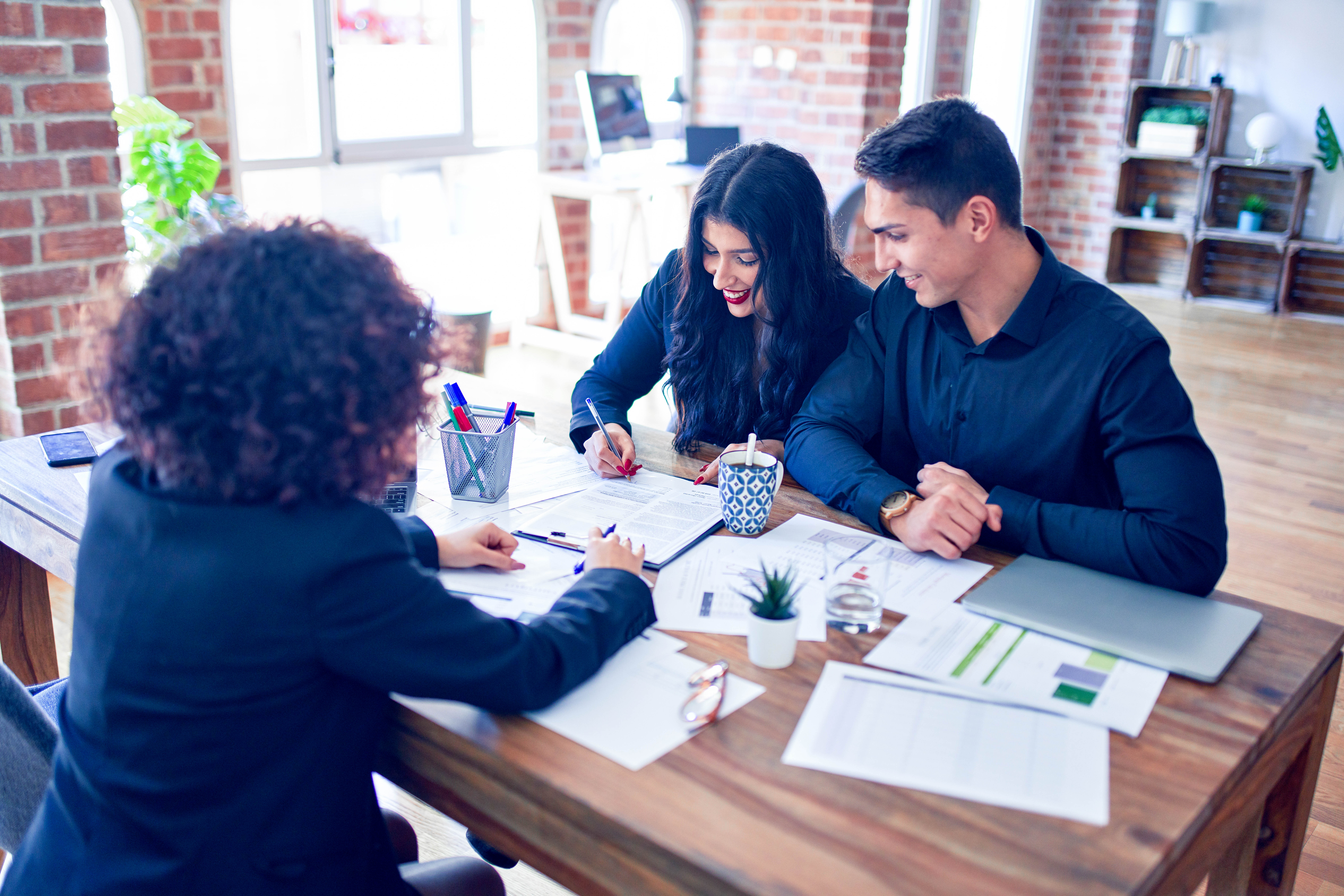 Young Couple Applying for Mortgage | Real Estate Law Services Calgary | Calgary Real Estate Lawyer | One80Law Group